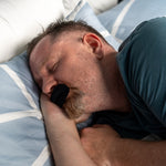 Mann sover med soveteip for å redusere snorking og forbedre søvnkvaliteten.